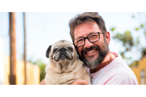 Man wearing glasses with smiling dog