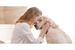 Woman cuddling with dog