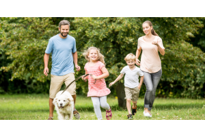 Family with pet dog in park