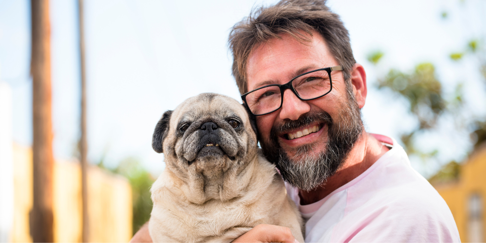 Man wearing glasses with smiling dog