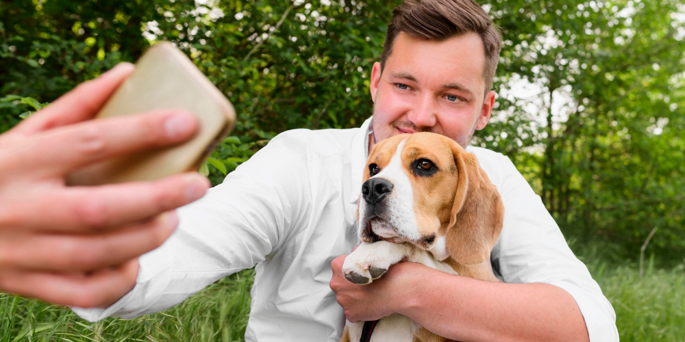 Man taking selfie with dog