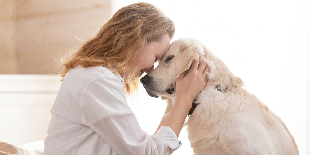 Woman cuddling with dog